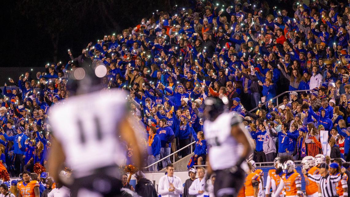Boise State fans hold up camera phone flashlights before the opening kickoff of a 2019 game at Albertsons Stadium.