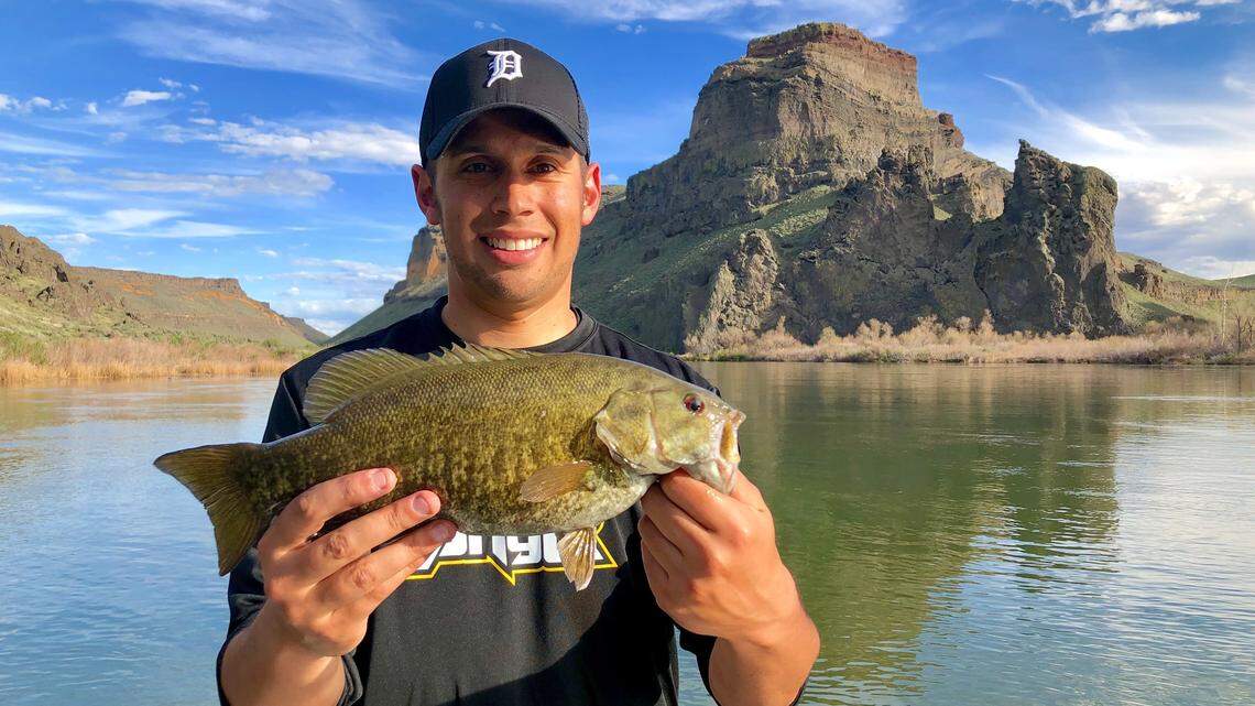The Snake River is running high — so be safe and cautious — but the early season bite is picking up for chunky, aggressive smallmouth bass like this one.
