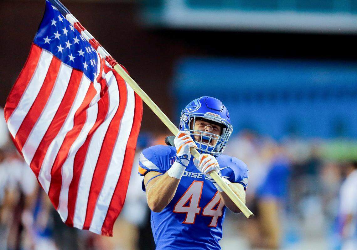 Boise State linebacker Riley Whimpey waves the American flag before last season’s game against Connecticut at Albertsons Stadium. Heading into Saturday’s game at BYU, Whimpey leads the Broncos with 33 tackles.