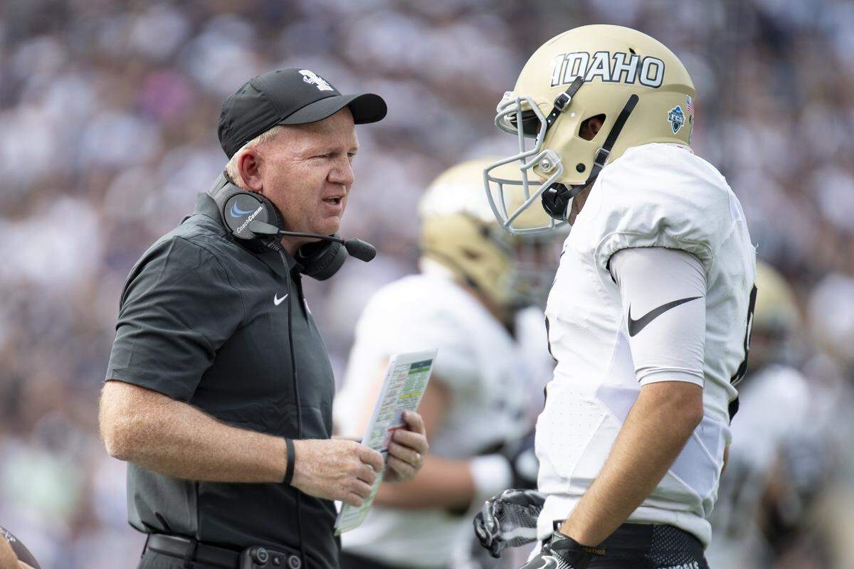 Idaho coach Paul Petrino talks with quarterback — and his son — Mason Petrino.