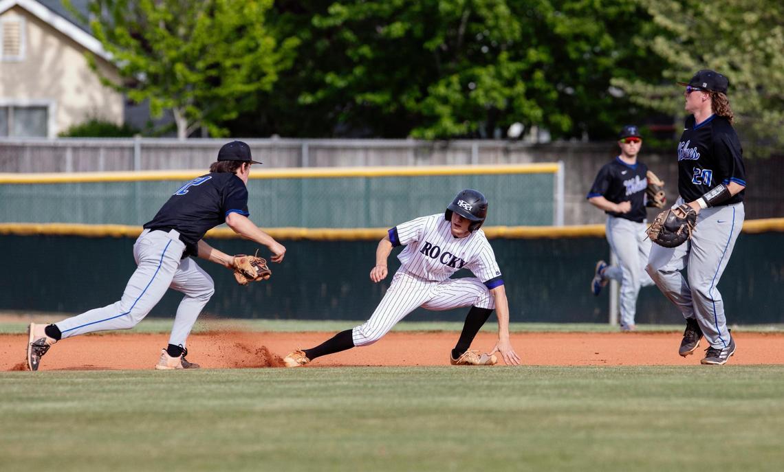 Rocky Mountain’s Kaden Menard (15) is tagged out as he’s trapped in between Timberline’s Logan Miller, left, and Cooper Sloan in Game 2 of the 5A District Three baseball championship series on Wednesday at Rocky Mountain.