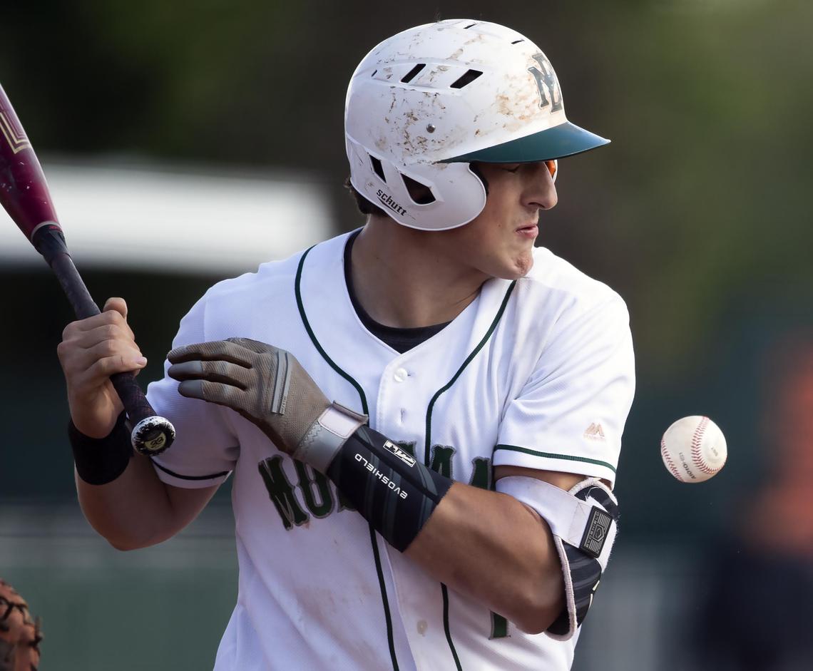 Eagle batter Matt Hudson takes an errant pitch to his arm during the Mustangs’ semifinal game against Mountain View during the 5A baseball state tournament.