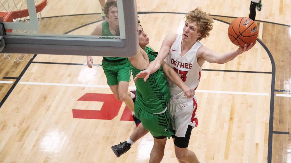 Owyhee sophomore Liam Campbell drives to the basket on Mountain View junior Dyson Judd on Tuesday at Owyhee High School.