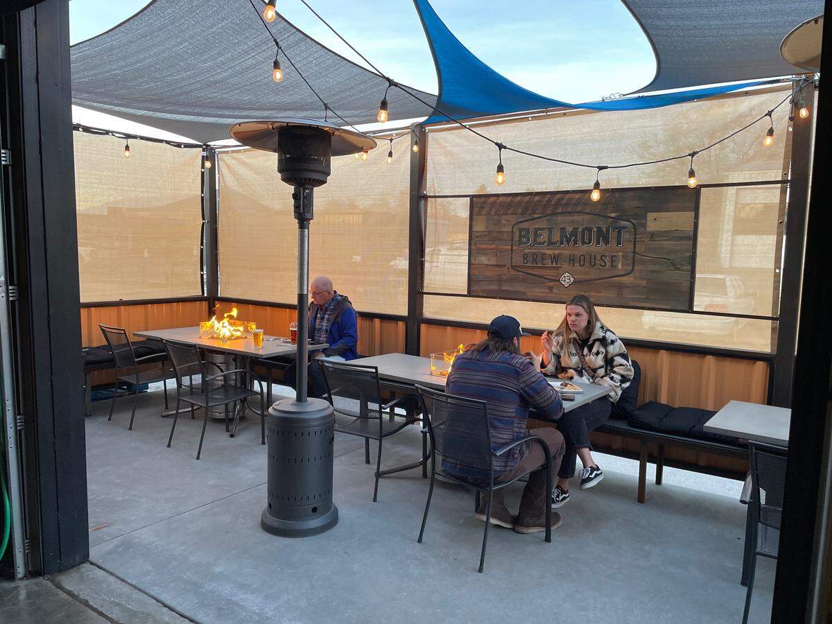 In addition to a small patio area out front, Belmont Brew House has a rear patio with fire features on tables.