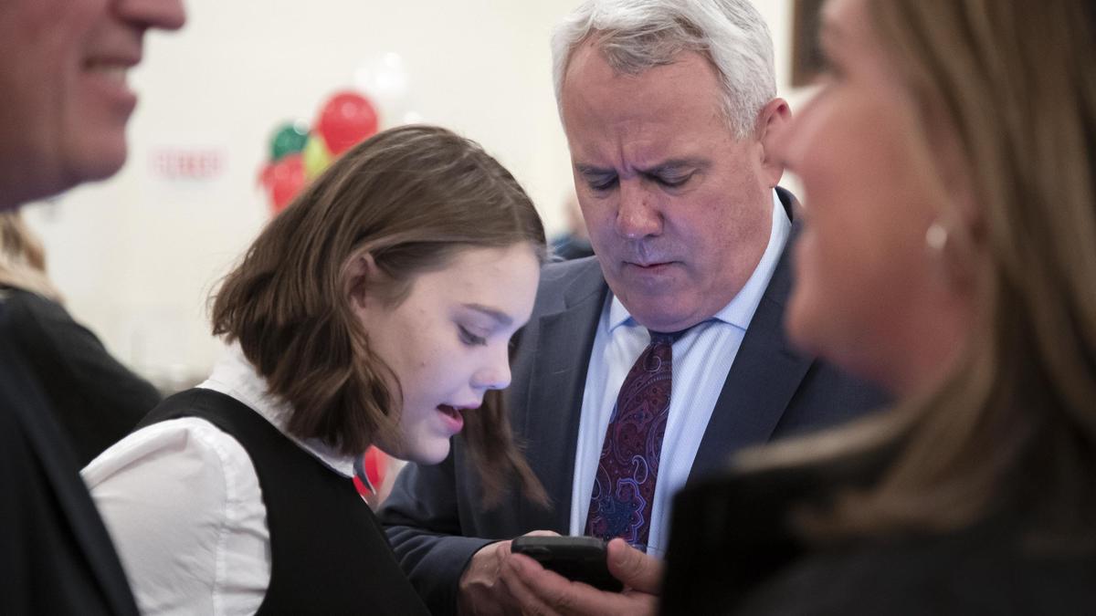 Boise Mayor David Bieter gets some help from his daughter, Josie Bieter, 14, to find election results Tuesday. Friends and supporters gathered at the Basque Center in Downtown Boise for an election night party.