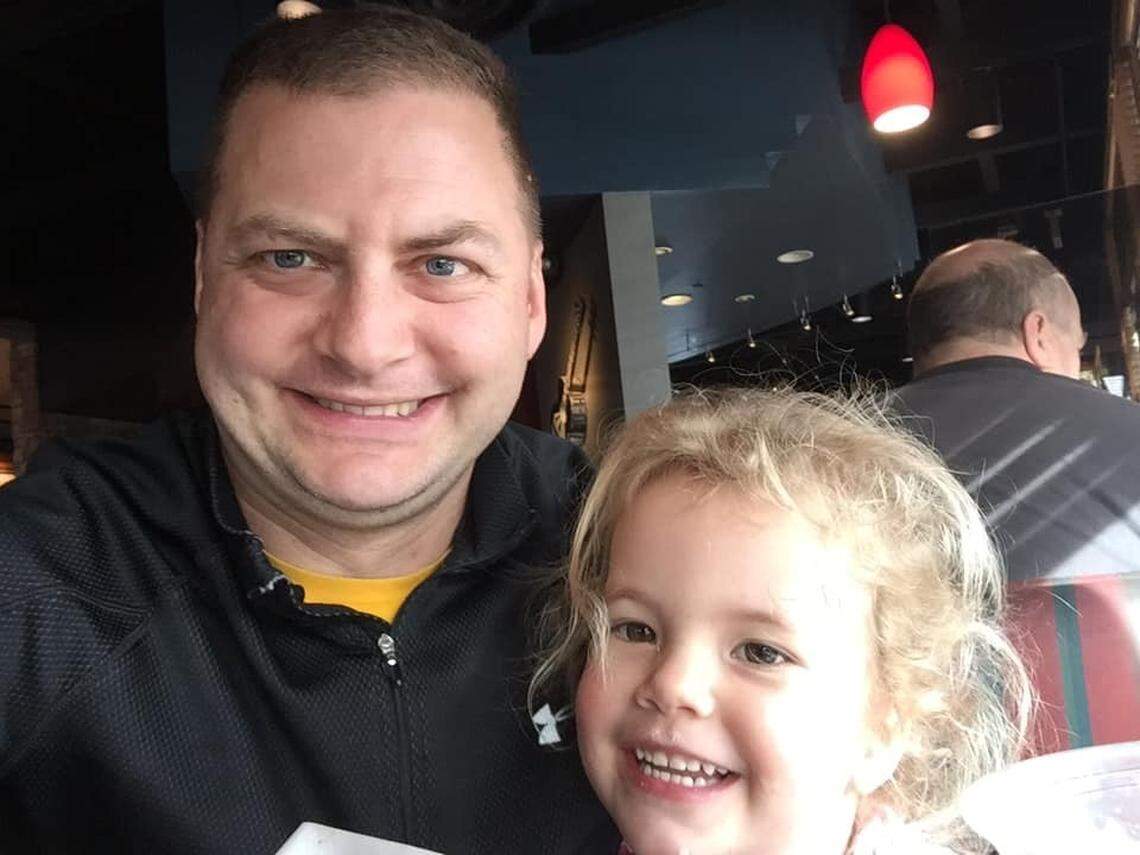 Chief Warrant Officer 3 Matthew Peltzer and one of his two children in an undated photo.