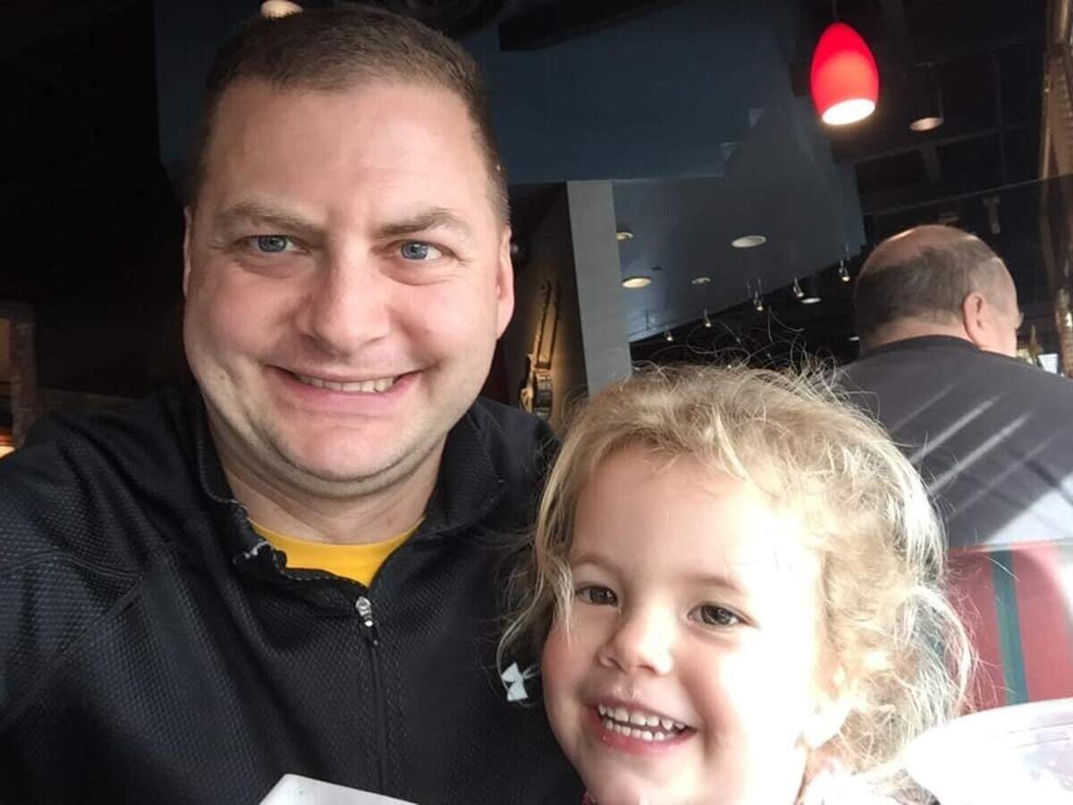 Chief Warrant Officer 3 Matthew Peltzer and one of his two children in an undated photo.