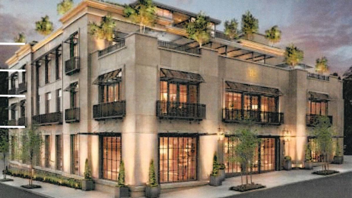 A drawing of a representative building at the Quarry Village development in Eagle shows ground-floor retail shops, with residences on the upper floors and a deck or other use on the rooftop.