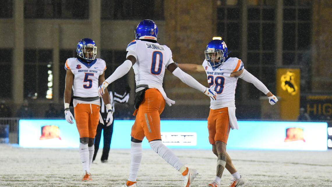 Boise State safety JL Skinner celebrates with nickel Kekaula Kaniho last season during the Broncos’ 17-9 win at Wyoming.