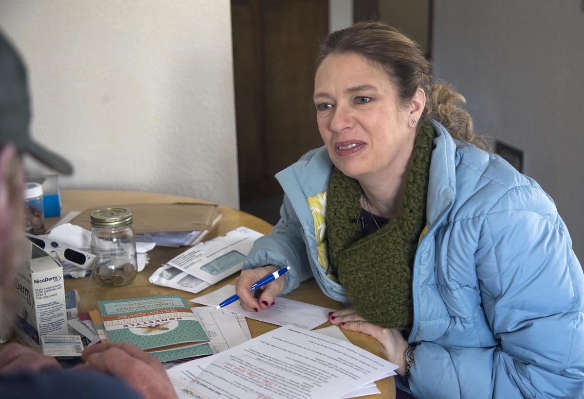 Shawn Briley goes over a health care form with one of her clients in McCall. She helps with paperwork, prescriptions and other tasks that some mental health patients can find overbearing or disorienting.