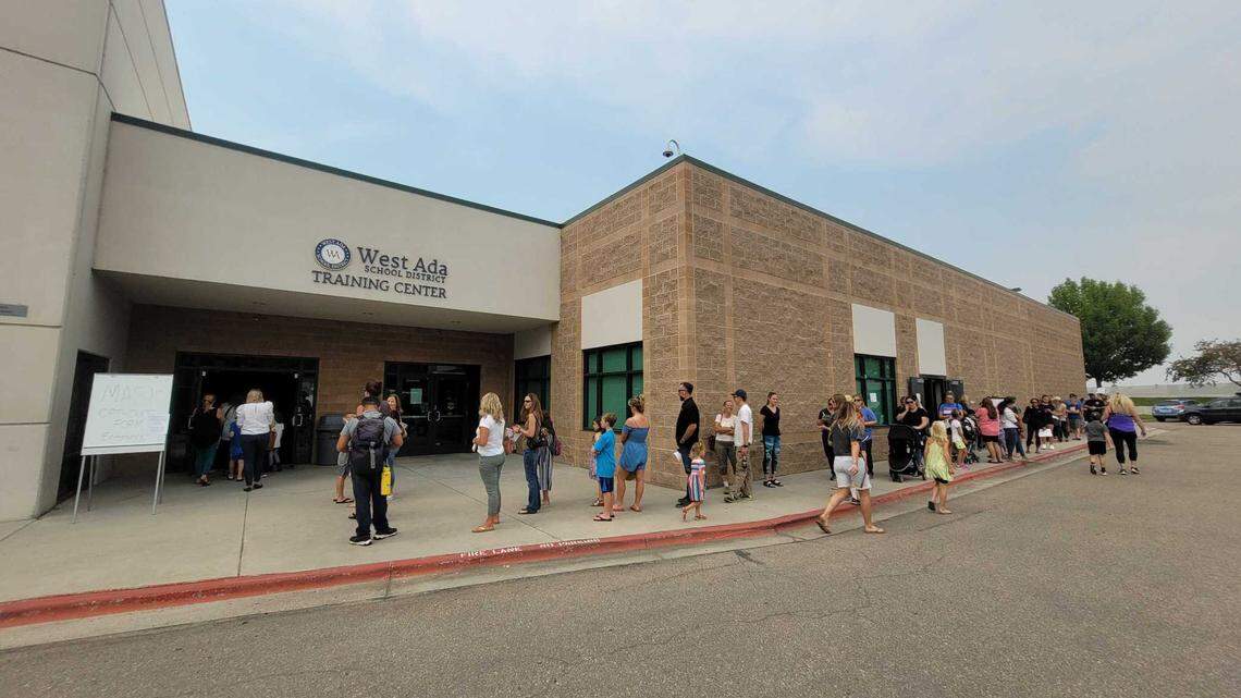 Parents and students on Wednesday line up outside the West Ada School District office to opt out of wearing a mask while at school.