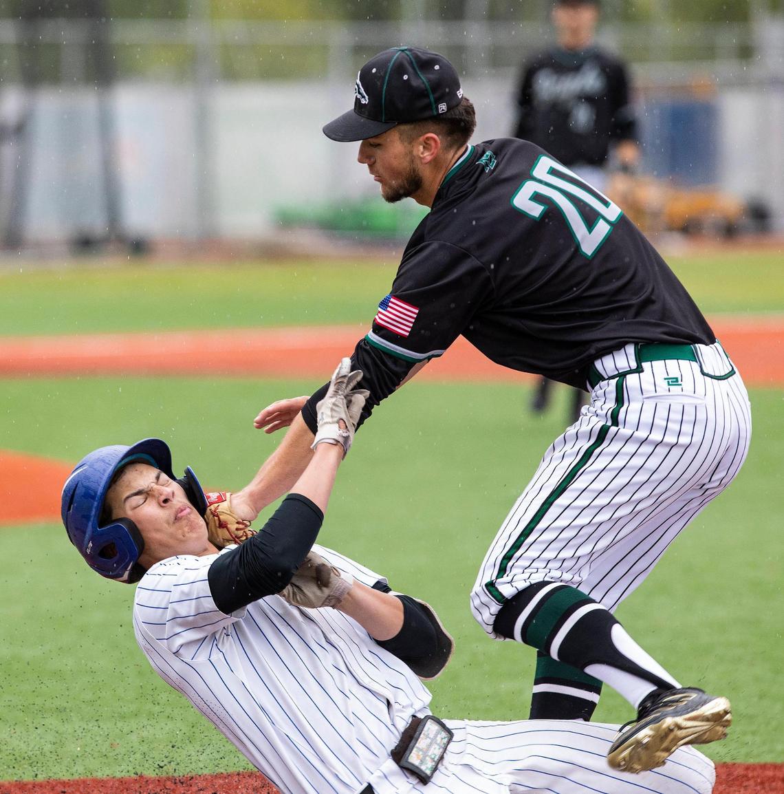 Eagle’s Lance Pike applies the tag to Timberline’s Greyson Shafer on Saturday at Wolfe Field in Caldwell.
