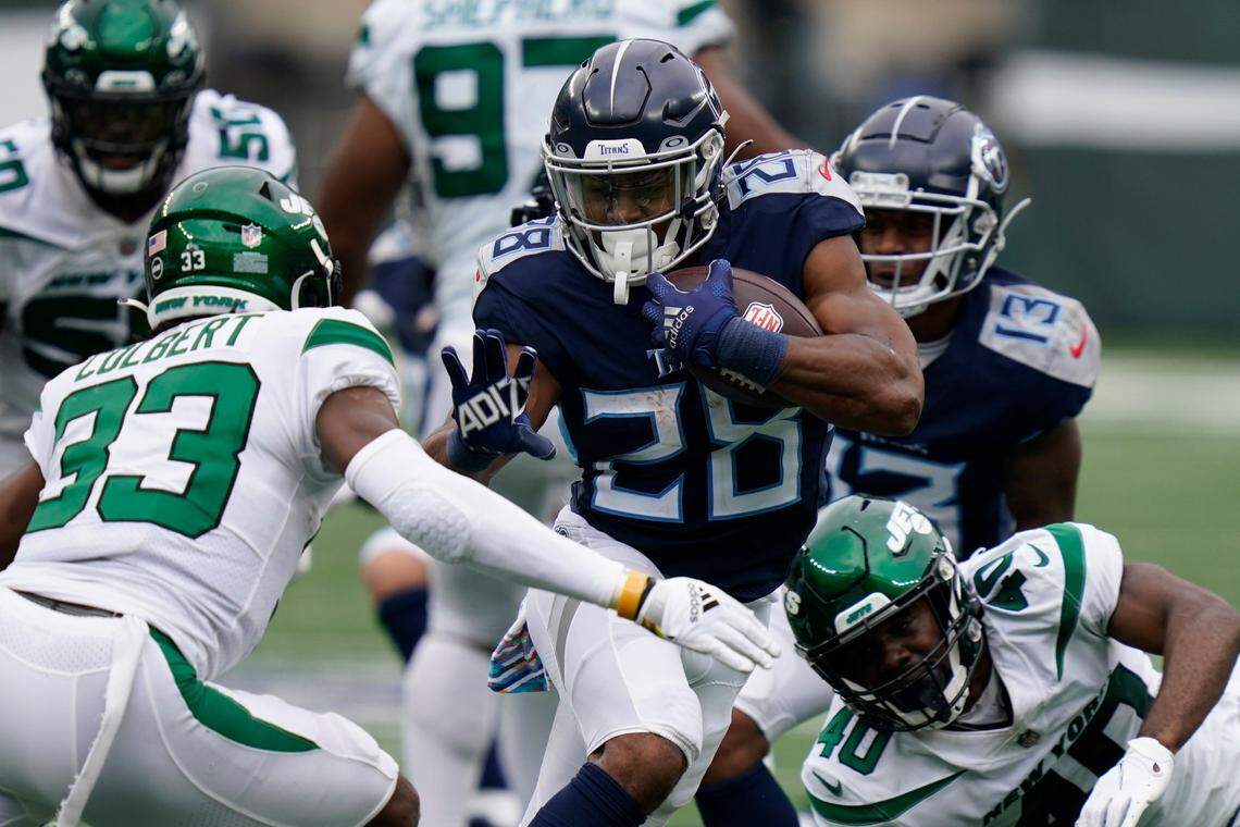 Tennessee Titans running back Jeremy McNichols goes for extra yards after a catch in the second half of the Titans’ 27-24 overtime loss to the New York Jets on Sunday in East Rutherford, N.J.