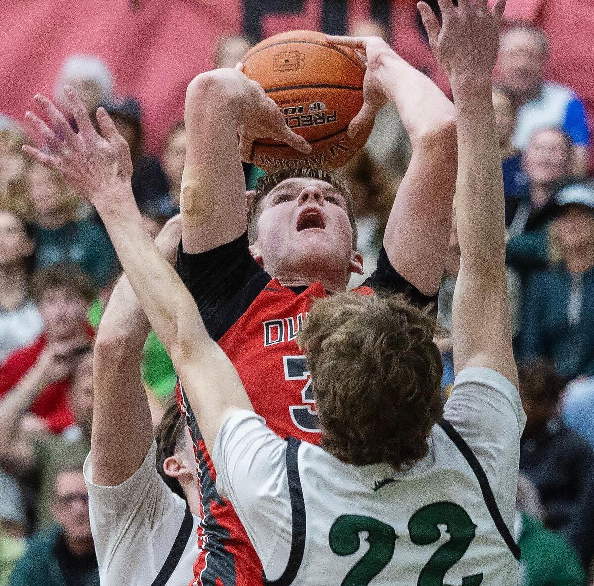 Owyhee senior Heath Sasser-Gunson battles through a pair of Eagle defenders Thursday.