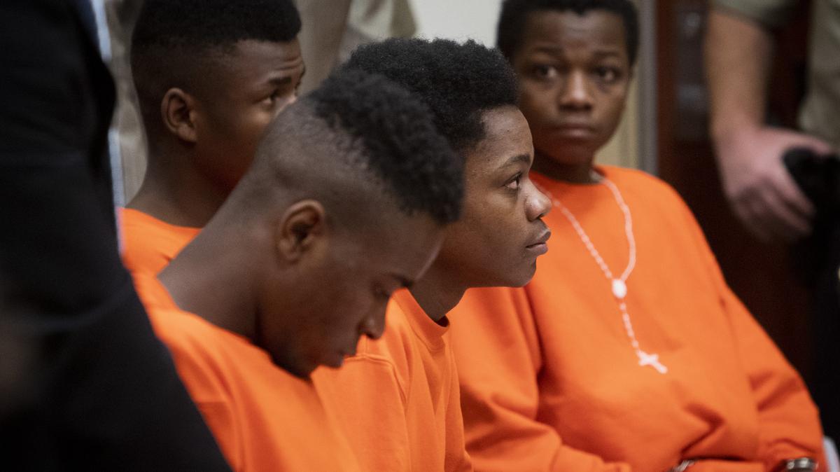From left, Swedi Iyombelo, 18; Elias Lupango, 19; Mulanga Rashidi, 18; and Ulimwengu Lupango, 16, appeared in court with their attorneys. They are accused of accused of raping an 18-year-old in Kuna in February. Their arraignment was postponed until April.