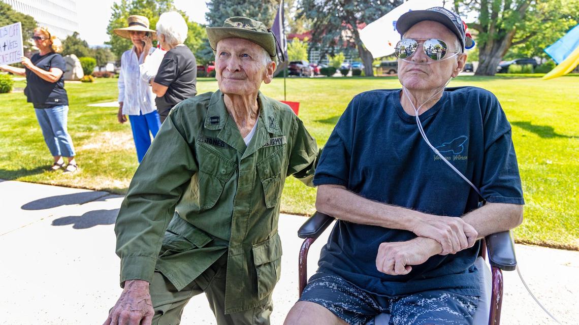 Army veterans Jim Jones, left, and James Peterson, right, talk about the issues facing veterans and VA employees due to funding cuts by the Trump administration during a protest outside of the Boise Veterans Affairs Medical Center during a protest, Friday, June 6, 2025.