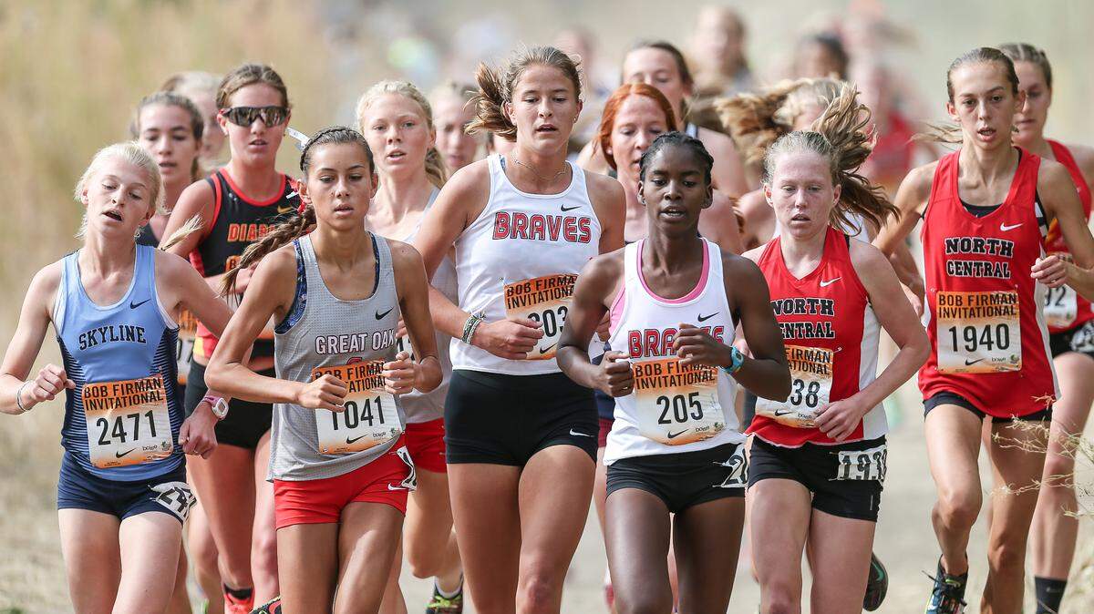 Great Oak’s Tori Gaitan (bib No. 1041), Boise’s Maggie Liebich (203) and Boise’s Rosina Machu (205) lead the pack during the elite girls race at the Bob Firman Invitational on Saturday at Eagle Island State Park. Gaitan won the race in 17:53.5.