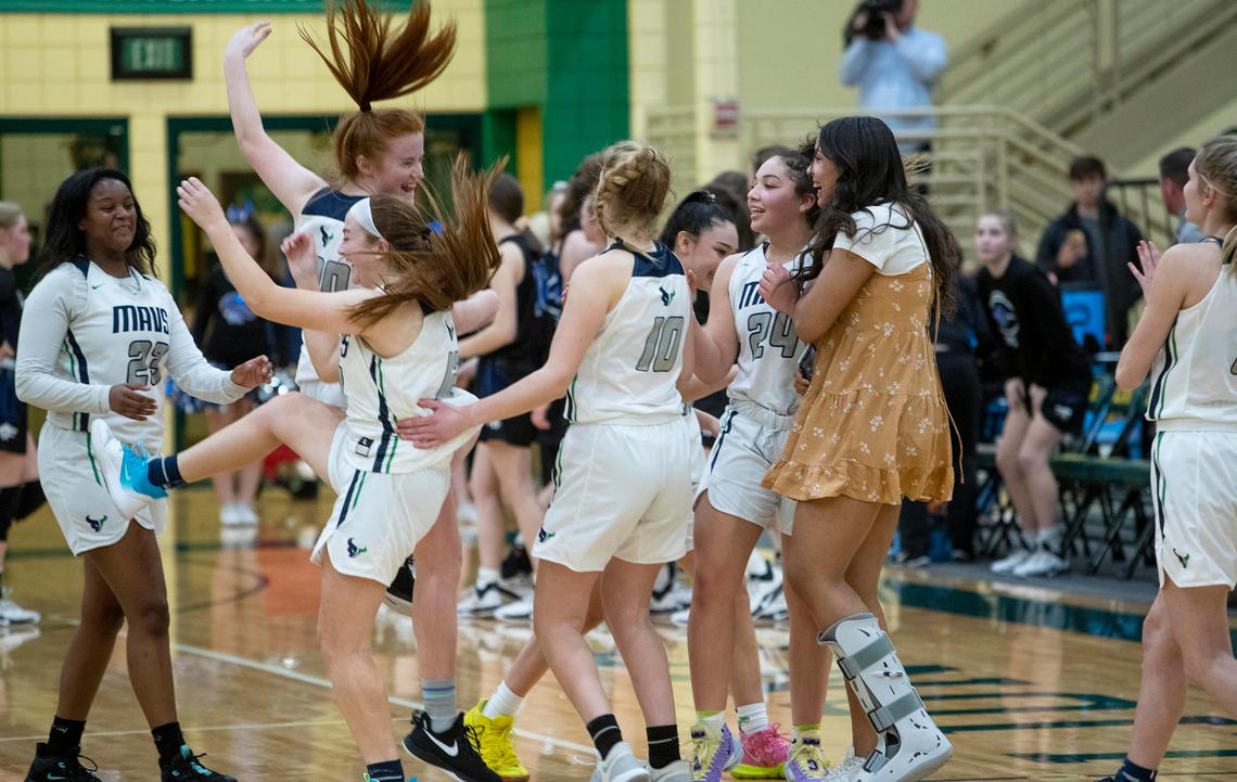 Mountain View celebrates a 61-56 victory over Timberline, winning the 5A District Three girls basketball championship Friday at Borah.