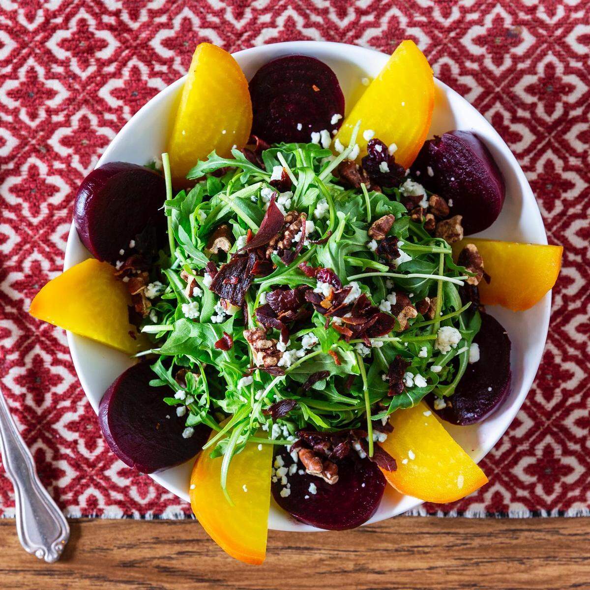 Beet salad ($9.95): Roasted red and golden beets, blue cheese crumbles, crispy prosciutto, arugula, toasted walnuts, dried cranberries, Italian dressing..