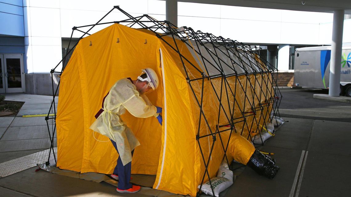 A Kootenai Health technician enters a COVID-19 testing tent outside of the emergency department entrance to the hospital in spring 2020.