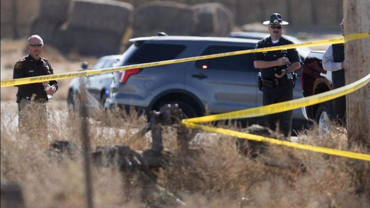 Officers are seen behind crime scene tape at the end of a high-speed chase that took place along Interstate 84 and country roads at noontime on Oct. 15.