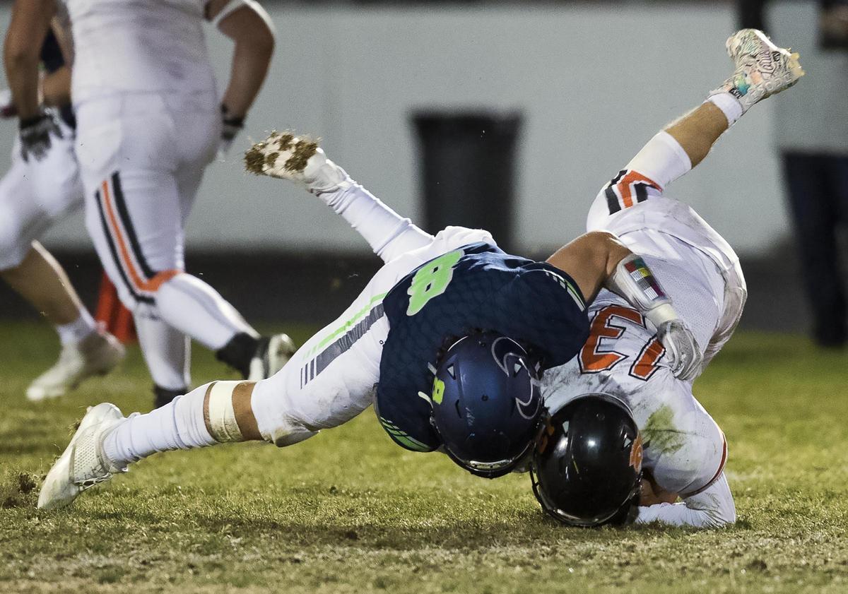 Mountain View linebacker Dylan Martinez plants Post Falls running back Tommy Hauser into the turf for a big loss last week during the 5A quarterfinals.