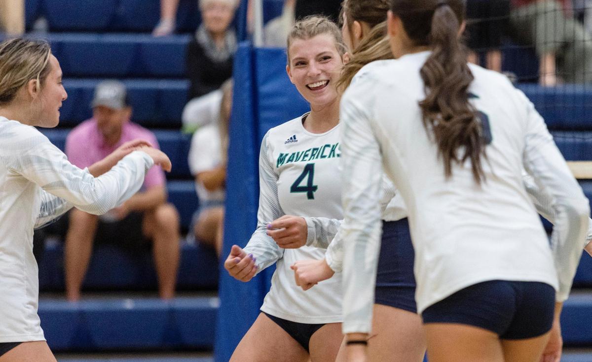 Mountain View senior Sierra Grizzle, center, smiles after winning their first set against Owyhee on Thursday, Sept. 15, 2022. The Mavs defeated the Storm 25-16, 25-21, 25-18 to remain unbeaten in 5A SIC play.
