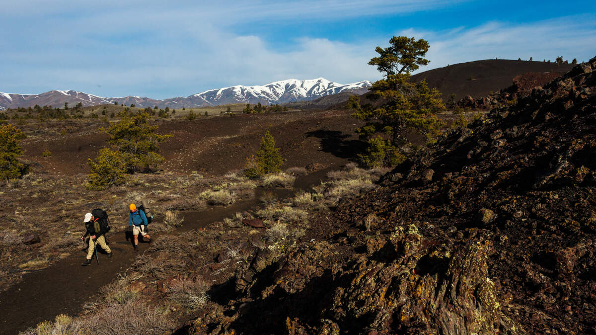 In this National Park Service file photo, hikers follow a trail through Craters of the Moon National Monument and Preserve. The area will celebrate its centennial in 2024.