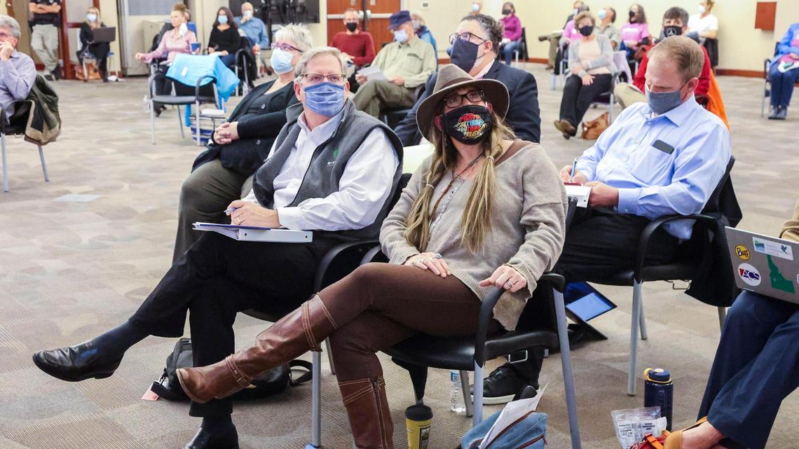 Jodi Peterson-Stigers, center, executive director of Interfaith Sanctuary Community Housing, views charts and maps during a presentation before the City of Boise Planning and Zoning Committee Monday, Nov. 15 at City Hall.