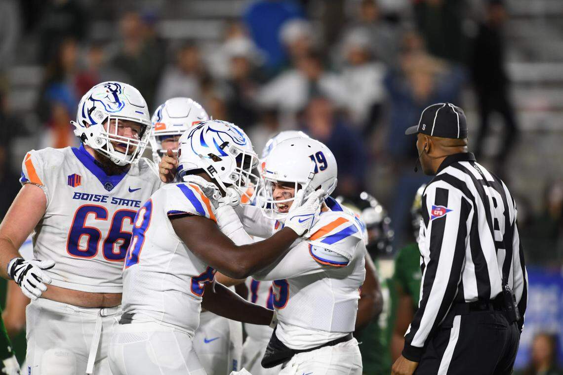 Quarterback Hank Bachmeier, right, congratulates tight end Tyneil Hopper after the two connected for a 51-yard touchdown pass at Colorado State. It was Hopper’s second career touchdown catch.
