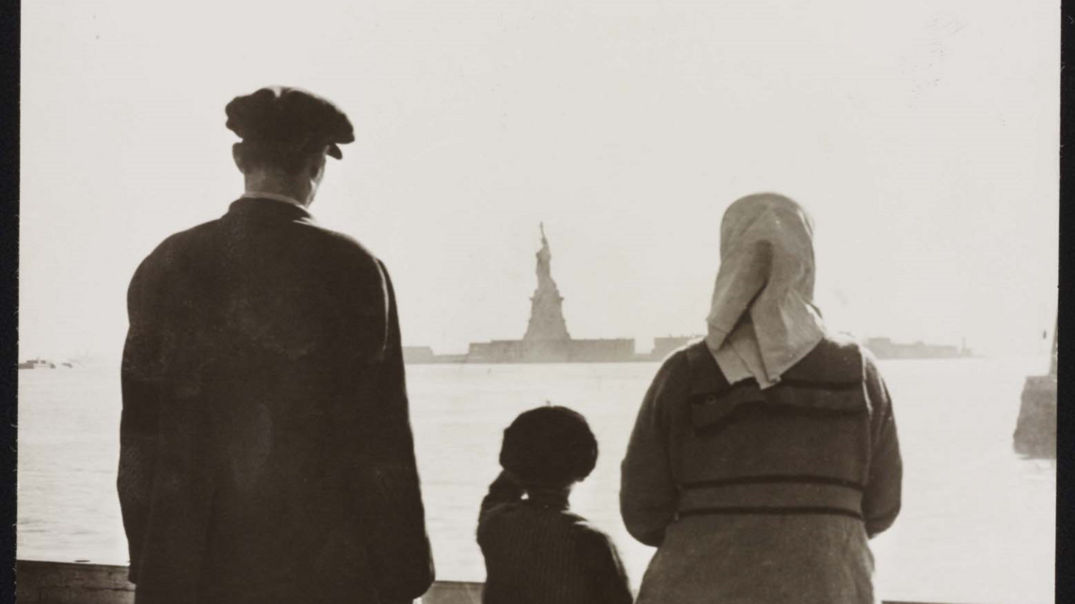 Photo shows immigrant family looking at Statue of Liberty from Ellis Island, ca. 1930. The PBS documentary “The US and the Holocaust” examines the rise of Hitler and Nazism in Germany in the context of global antisemitism and racism, the eugenics movement in the United States and race laws in the American south.