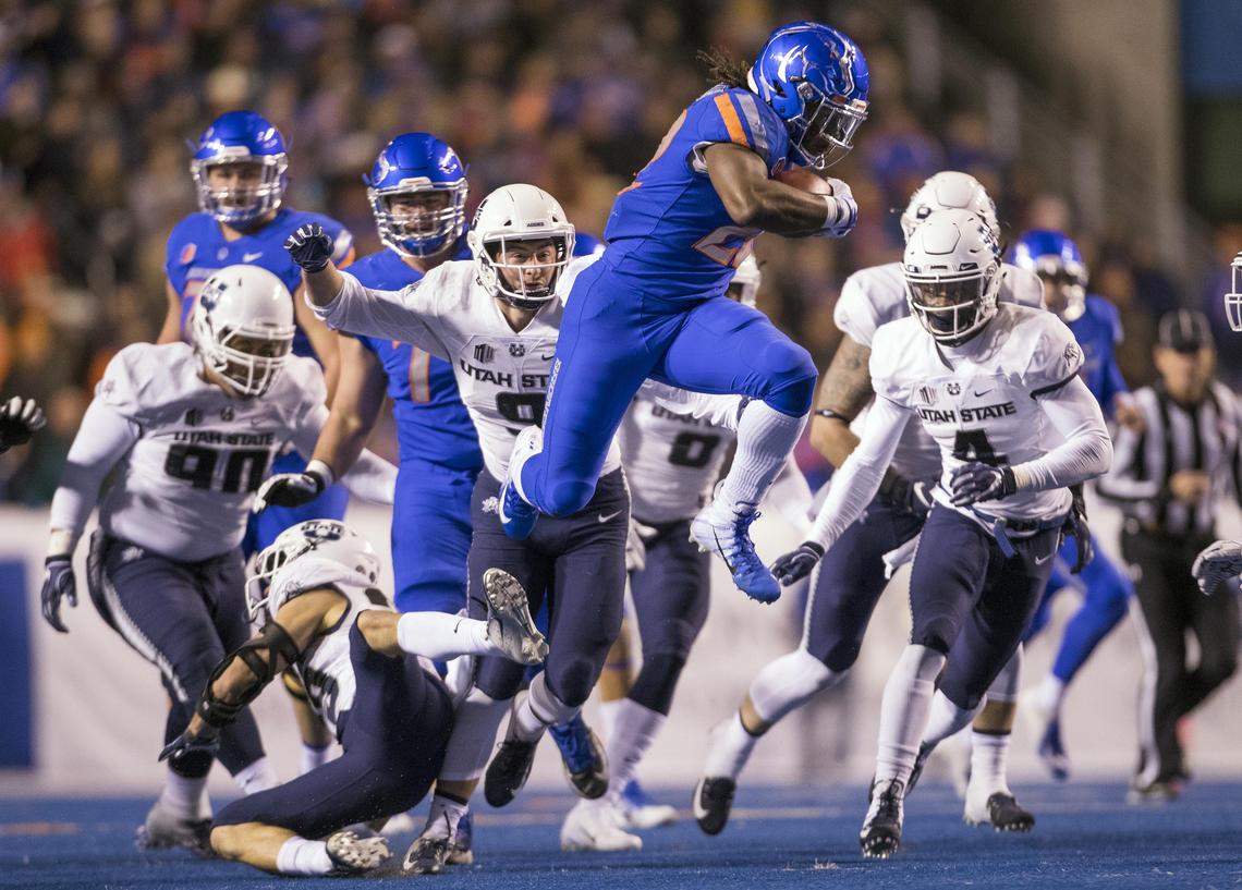 Boise State running back Alexander Mattison (22) hurdles Utah State safety Gaje Ferguson (23) and gains a first down in the second quarter Saturday, Nov. 24, 2018 at Albertsons Stadium in Boise.