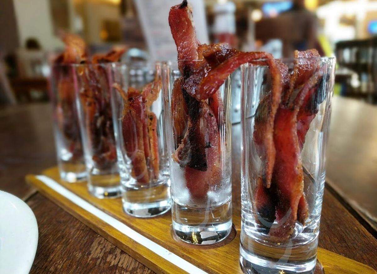 Five different flavors of bacon, served in shot glasses, are part of the $14 combo at Bacon.