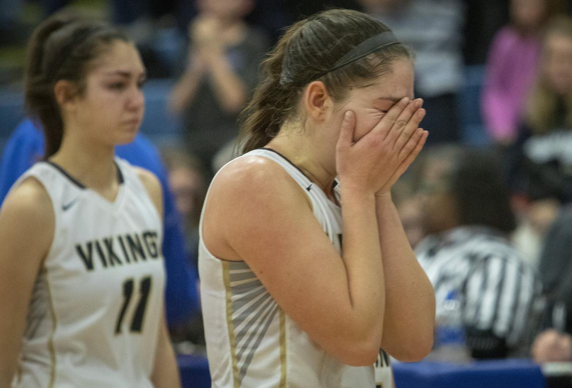 Middleton forward Lexi Mitchell reacts after Middleton’s 34-40 loss to Century in the semi-final round of the 4A state girls basketball championship at Timberline High School on Friday, Feb. 15, 2019.