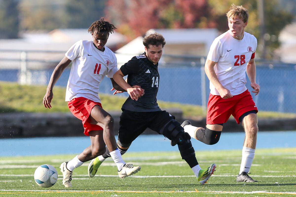 Boise’s Alex Hoefer, left, scored the winning goal on a penalty kick in overtime in the 6A boys soccer state championship game Saturday at Coeur d’Alene High School.