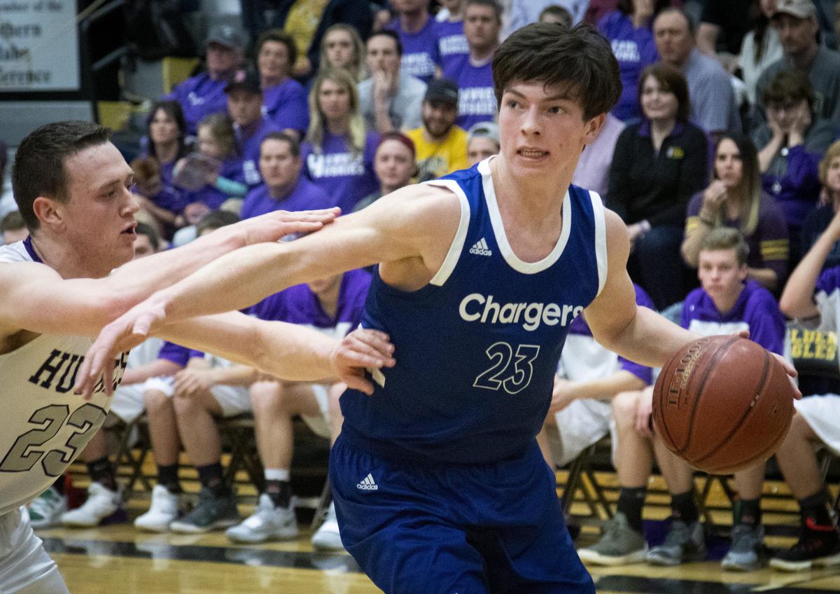 Cole Valley’s Dylan Krogh charges the basket under pressure from North Fremont’s Paul Wynn. Cole Valley vs. North Fremont in the semi-final round of the 2A state boys basketball championship tournament on Friday, March 1, 2019, at Capital High School.
