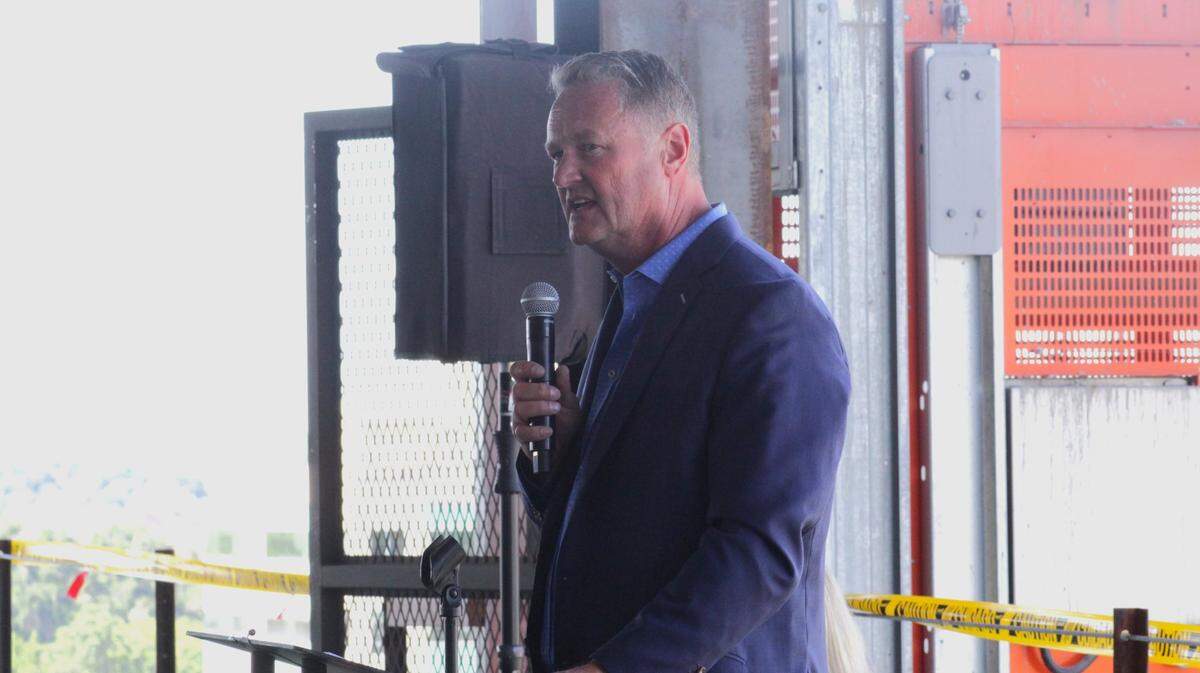 Developer Tommy Ahlquist speaks at the “topping off” ceremony for the new building.