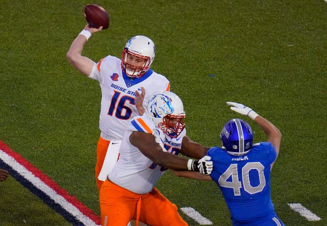 Boise State quarterback Jack Sears throws a pass as offensive lineman John Ojukwu, front left, blocks Air Force linebacker Alec Mock during the second half of their game Saturday at Air Force Academy, Colo.