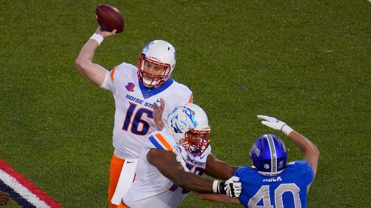Boise State quarterback Jack Sears throws a pass as offensive lineman John Ojukwu, front left, blocks Air Force linebacker Alec Mock during the second half of the Broncos’ 49-30 win at Air Force.