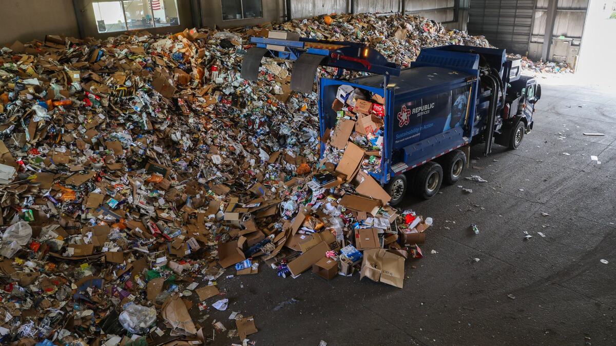 A Republic Services truck unloads recyclable waste at the center in Boise in March. The trash is pushed onto a conveyor, where crews sort recyclables like paper, aluminum and plastics.