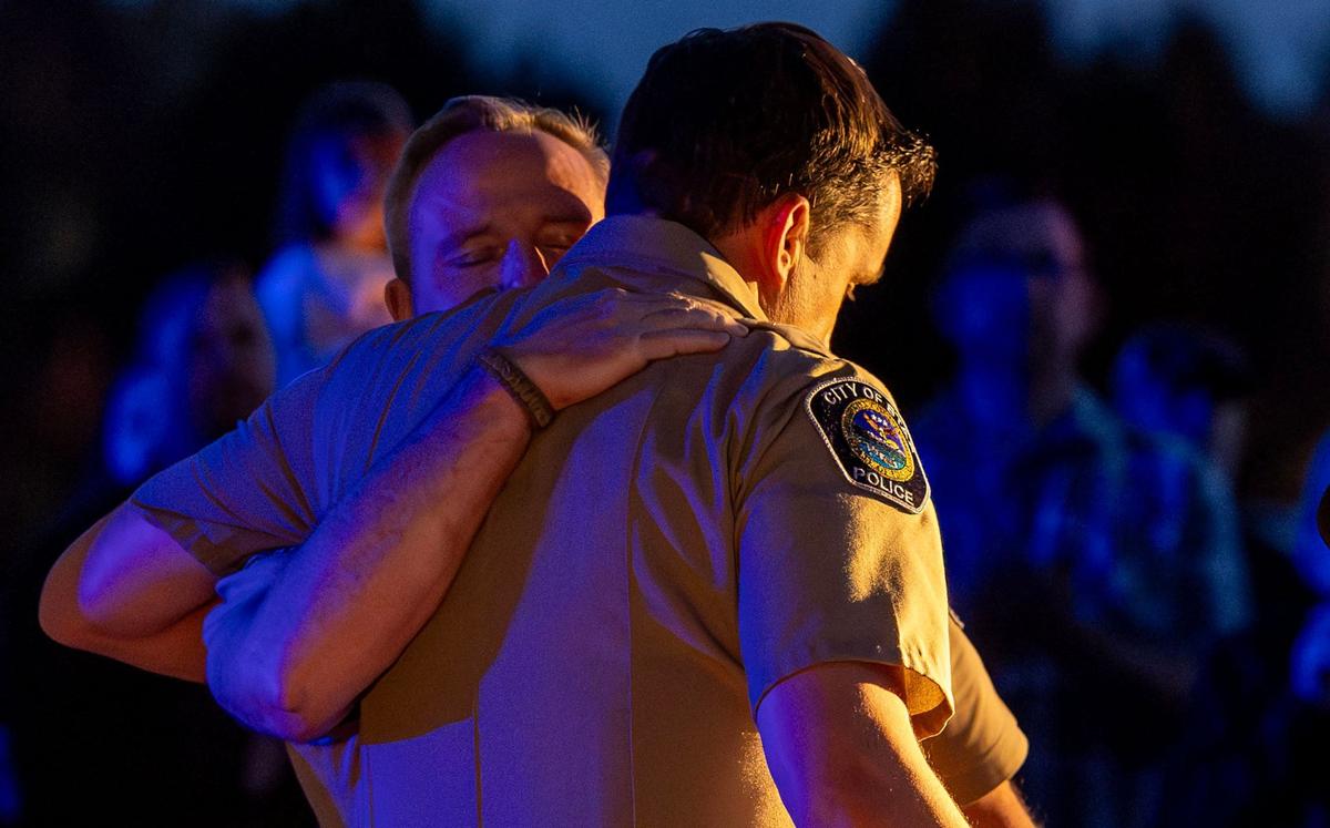 Ada County Sheriff Matt Clifford hugs Star Police Chief and Ada County Sheriff’s Sgt. Zach Hessing as the two share comments with hundreds of people who gathered to honor Deputy Bolter at a vigil April 23 in Star. 