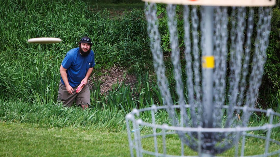 Franklin Brien throws from a rough patch while playing a round of disc golf at Ann Morrison Park in Boise. He started playing disc golf avidly last fall, he said.