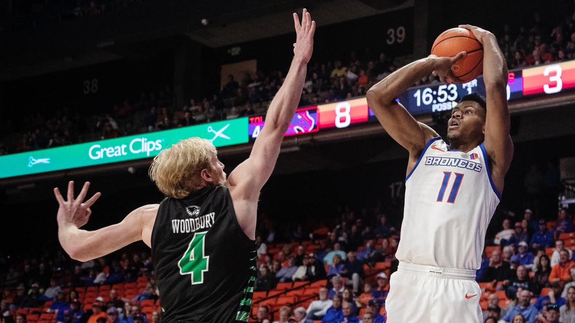 Boise State’s Chibuzo Agbo shoots past Utah Valley’s Trey Woodbury to score during the first half of a men’s basketball game Saturday at ExtraMile Arena.