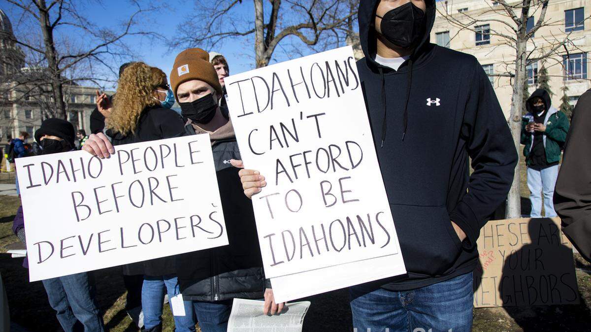 Julian Arreguin Vega of Boise holds a sign while attending a protest in January.