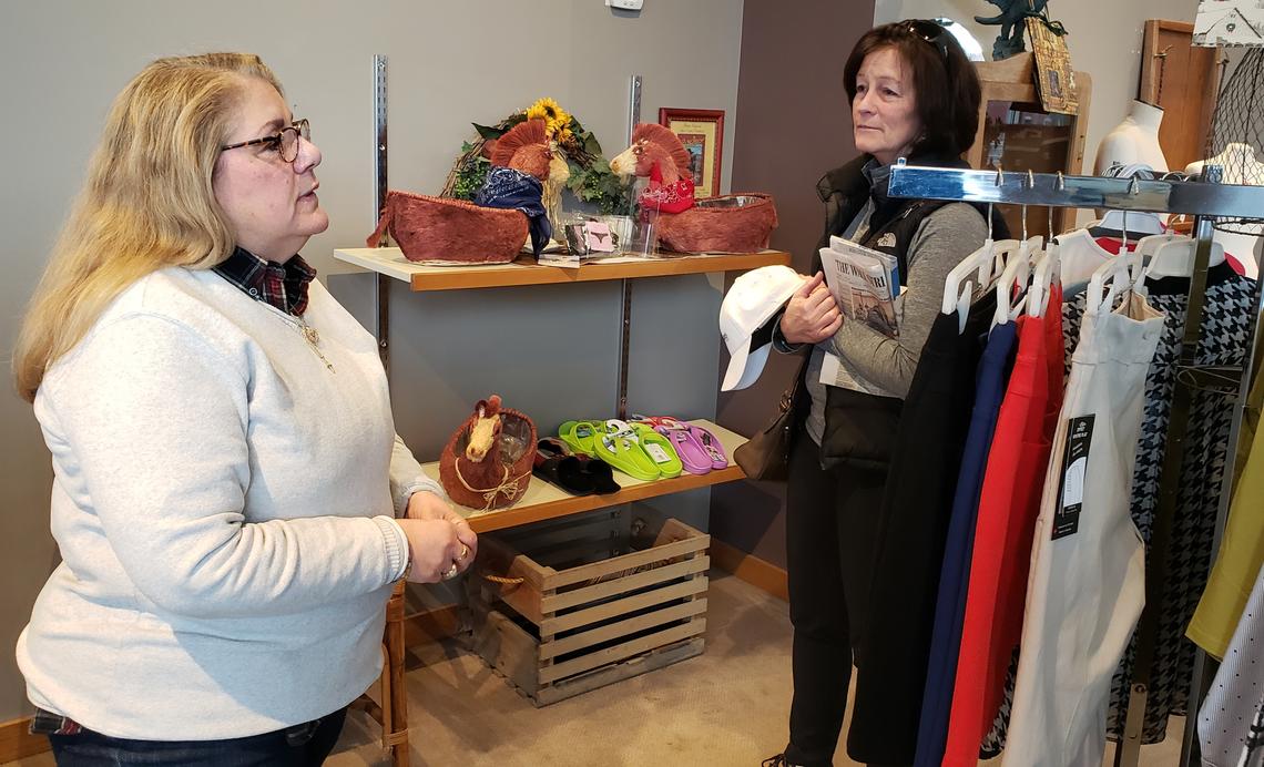 American Clothing Gallery customer Kristen Weitz, right, tells store owner Lil Kurek that she’s sorry Kurek is closing her store. “She’s always carried high-quality clothes,” Weitz said.