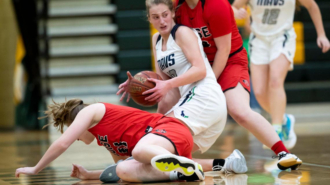Mountain View senior McKenzie Cook gains possession of a loose ball in a scramble with Boise’s Madi Williams and Breana Hallam during the 5A District Three girls basketball semifinals Saturday at Borah High.