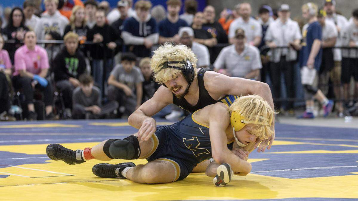 Caldwell's Jaxson Freeman, top, and Meridian's Justus Briggs, bottom, compete in the 6A 126-lbs. division first place match at the Idaho state wrestling championships held at the Ford Idaho Center in Nampa, Saturday, Feb. 28, 2026. Freeman won.