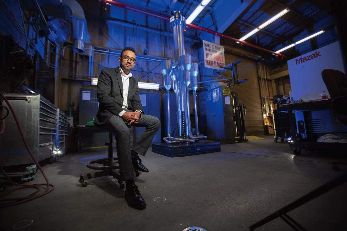 Yasir Arafat sits near a prototype of his MARVEL nuclear microreactor.
