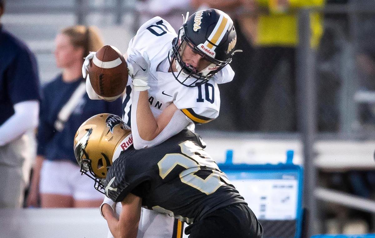 Capital’s Brody Call delivers a punishing hit on Meridian’s Quentin Riley last season at Dona Larsen Park.