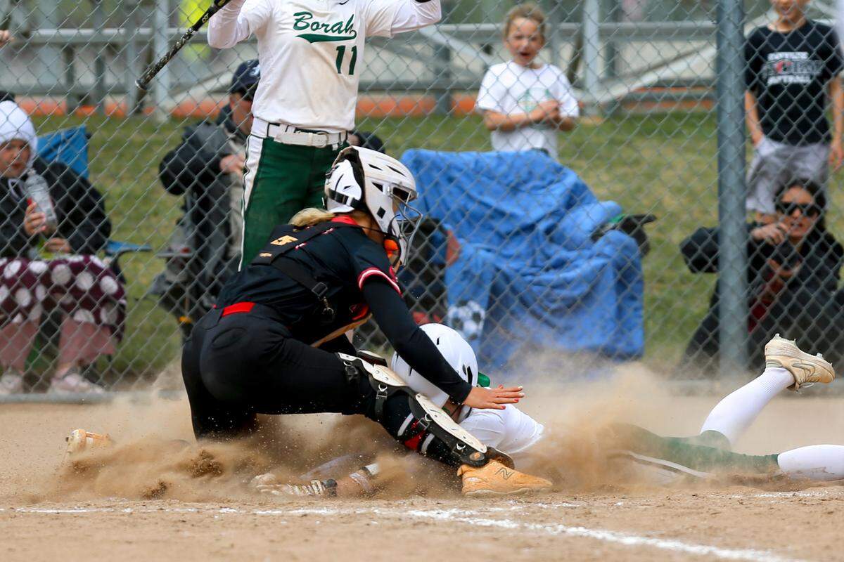 Borah’s Rylee Nelson slides safely into home against Owyhee in the 5A state championship game May 17 at Post Falls High.